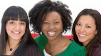 faces of three women of diverse ethnicities together smiling