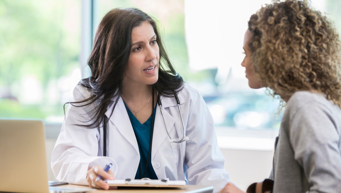 Mature doctor discusses health issues with patient