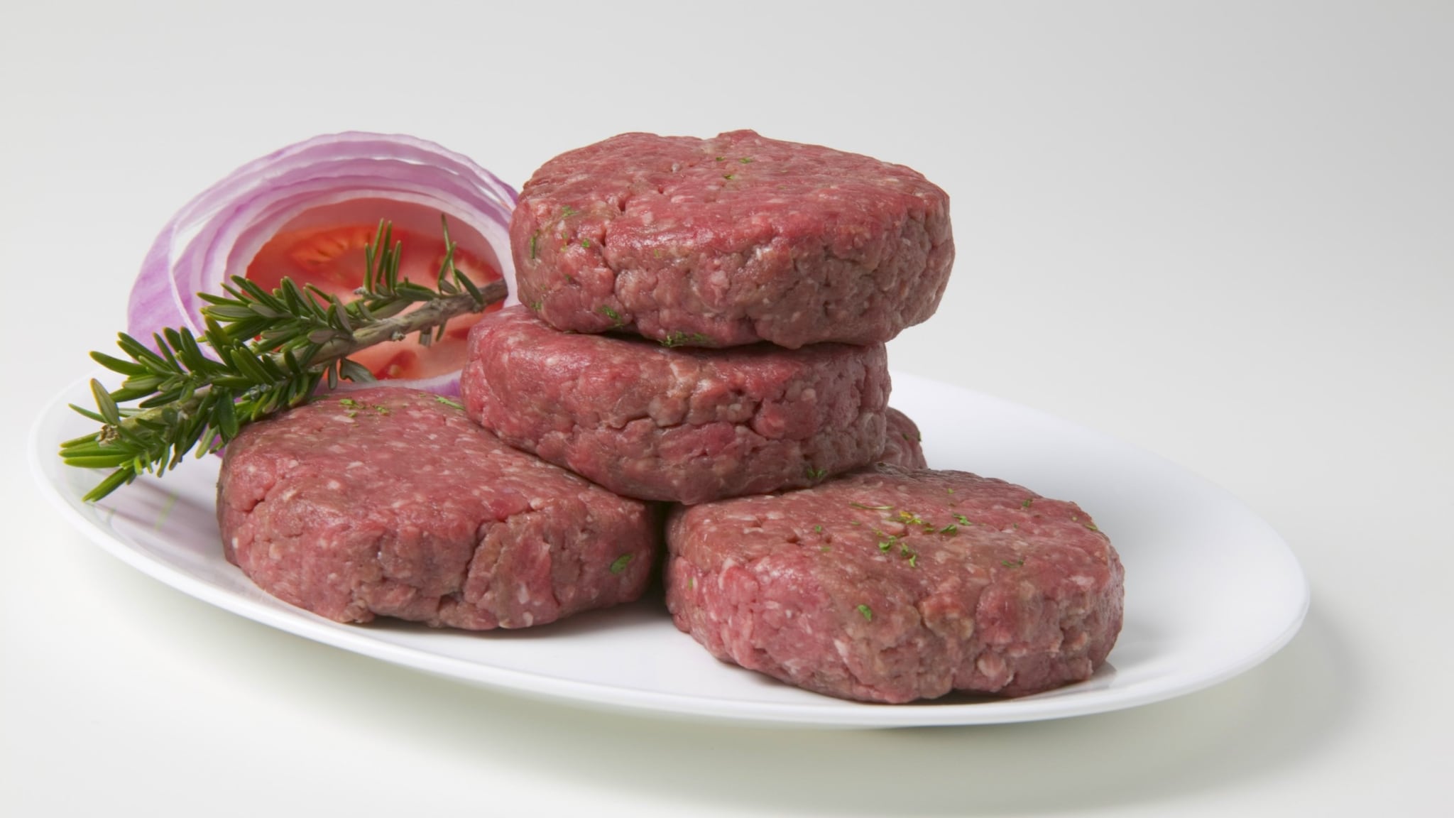 plate with patties of ground beef