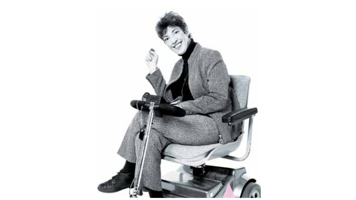 June smiles while sitting in her electric scooter.