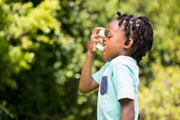 A child using an inhaler 