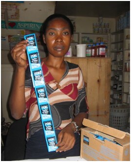 Woman with PUR sachets in Haiti, D. Lantagne, CDC