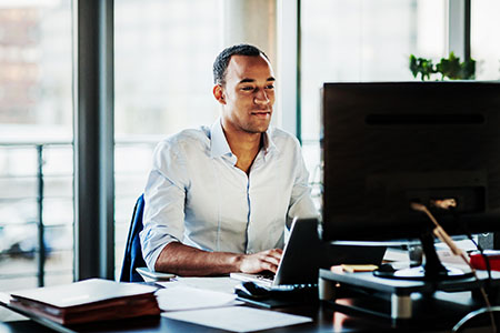 A man working on his computer at his desk