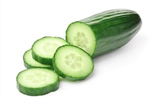 image of a cucumber half sliced with a white background