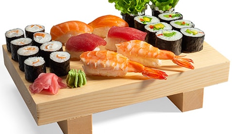 Sushi set and sushi rolls on a wooden board
