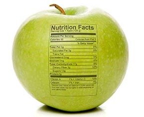 A green apple with a nutrition label stamped on it.