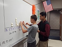 students working on white board