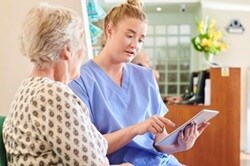 Photo of a patient navigator helping a patient schedule an appointment