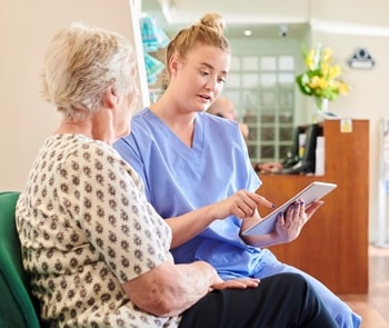 Photo of a patient navigator helping a patient schedule an appointment.
