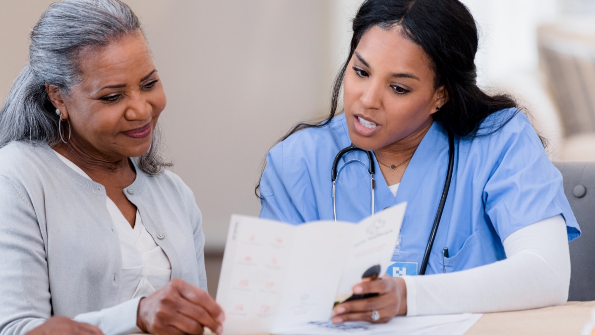 Health Care Provider Speaking with a Patient and looking at a Brochure