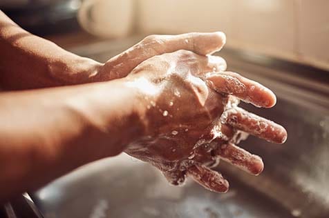 rubbing soap-sudsed hands together