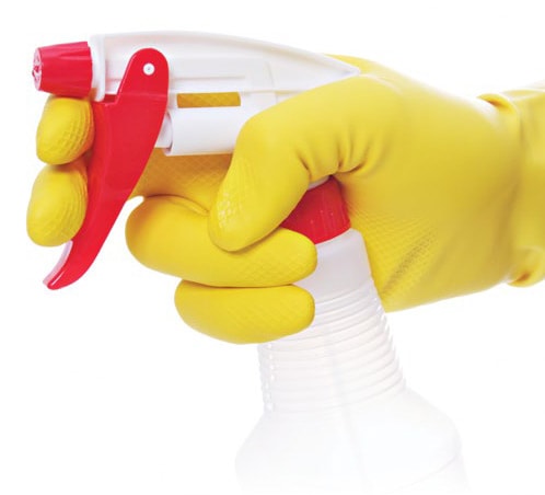gloved hand holding spray bottle containing bleach