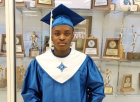 Joshua Adekunle wearing a graduation cap and gown