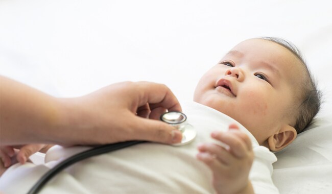 Un médico examinando a un bebe con un estetoscopio