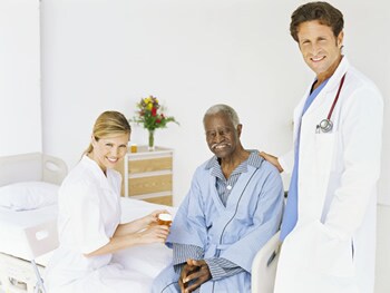 Photo: Doctor and nurse with older adult male patient