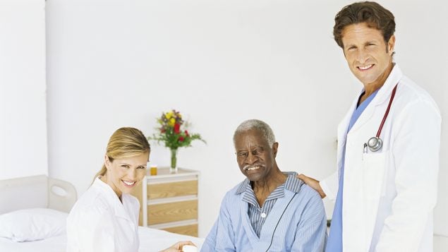Doctor and nurse with older adult male patient