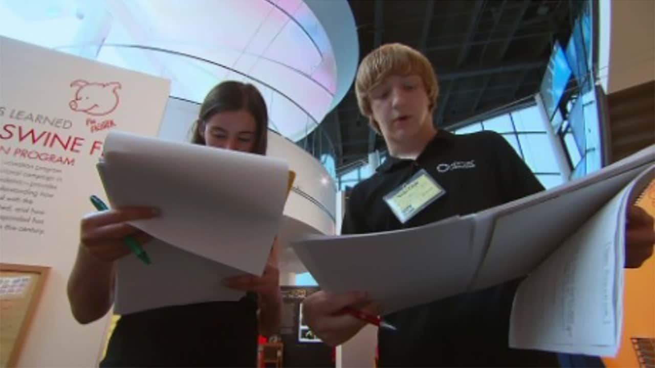 Two students looking at a document