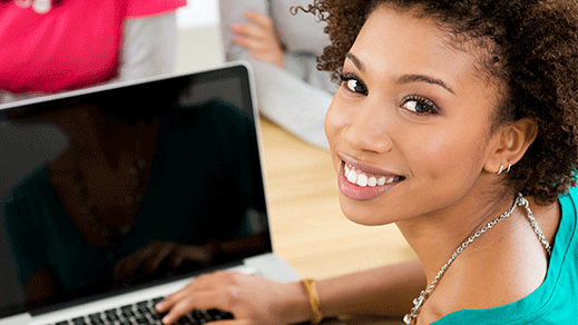 Young, Woman of Color using a laptop