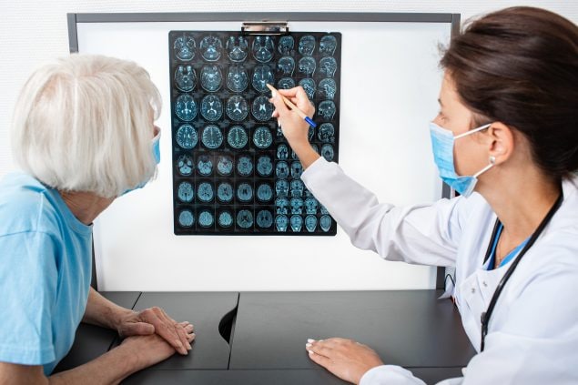 Doctor explains to an elderly woman the results of an MRI sc…