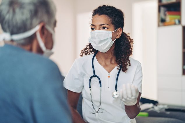 Female doctor talking with a senior patient