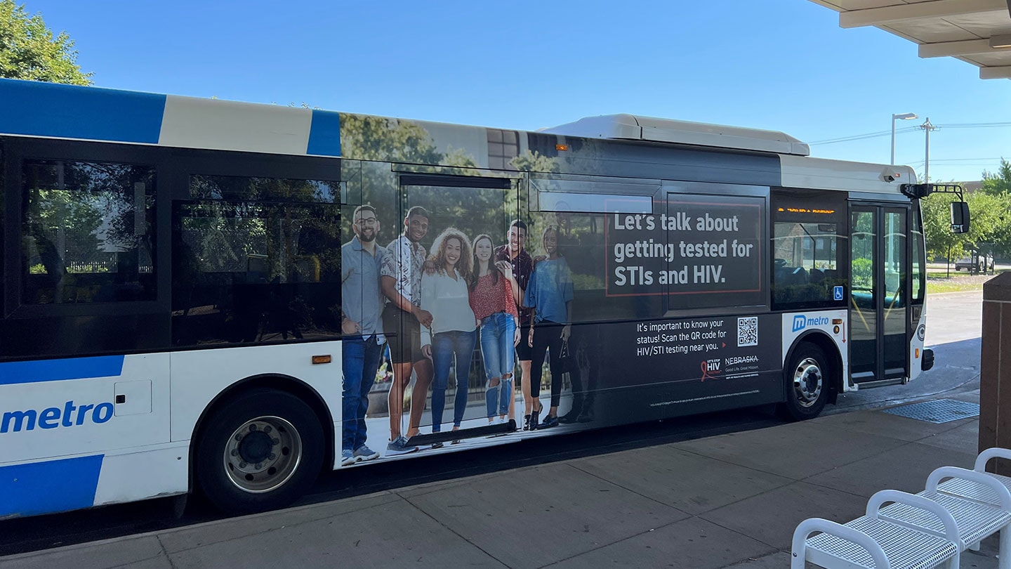 Photograph of bus with Let's talk about getting tested for STIs and HIV signage