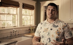Hawaiian male standing in kitchen talking to camera