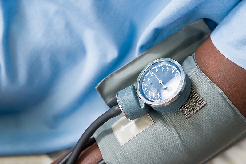 A blood pressure cuff on a man's arm.