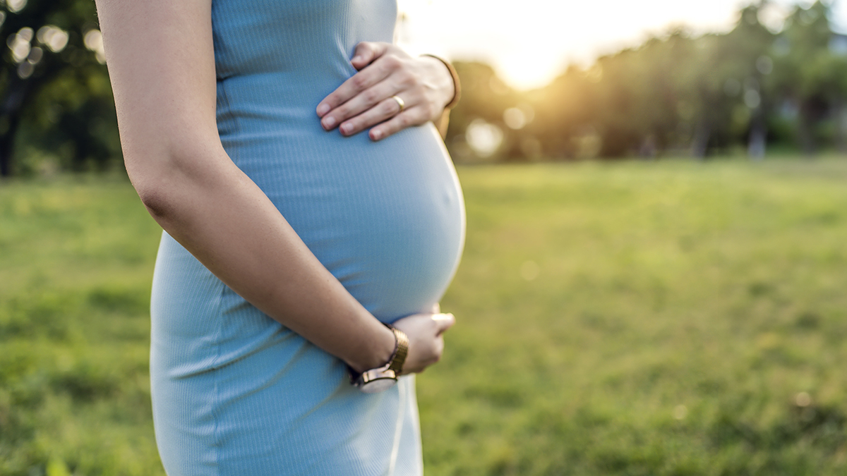 Pregnant woman holding stomach