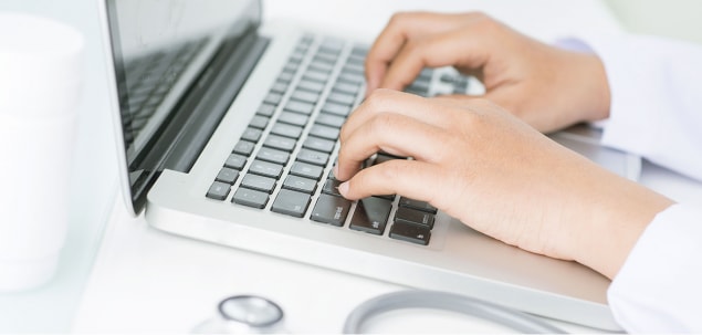 Image of a woman typing on a computer