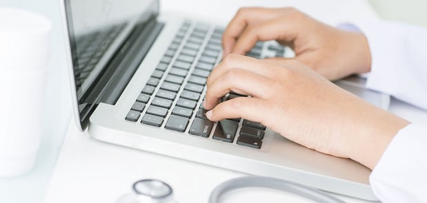 Image of a person typing on a computer