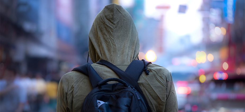 person wearing hoodie with a backpack