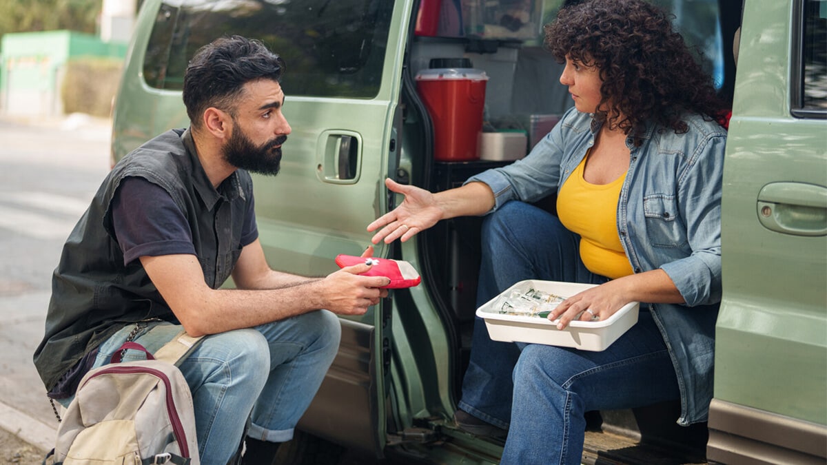 A mobile syringe services program (SSP) worker counsels a client from a van.