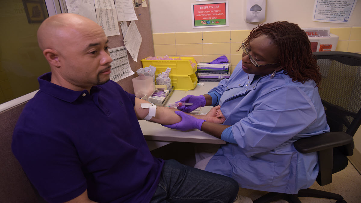 A healthcare provider administers an IGRA test to a patient.