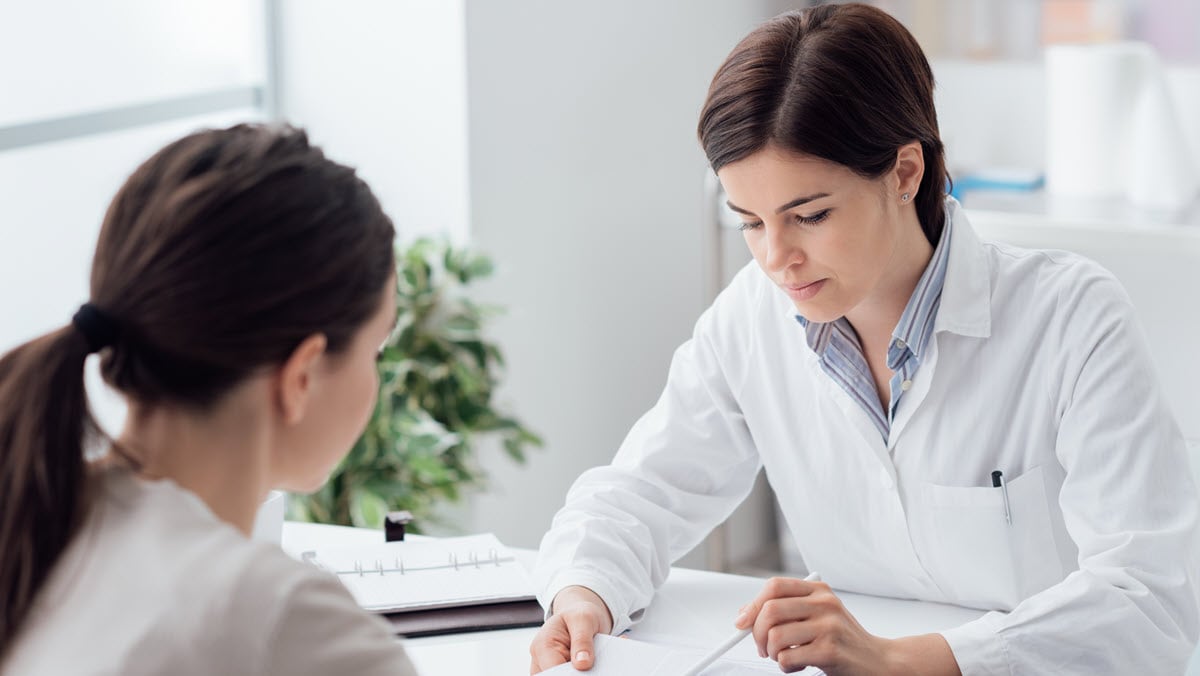 A female health care provider reviews test results with a female patient.
