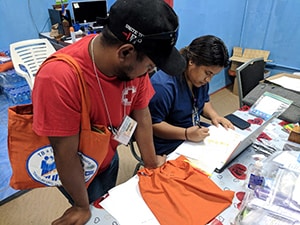 Photo Caption: Community worker Joel Bujen and Nurse Adela Sibok-Nakamura prepare 3HP for community distribution in Majuro in June, 2018.