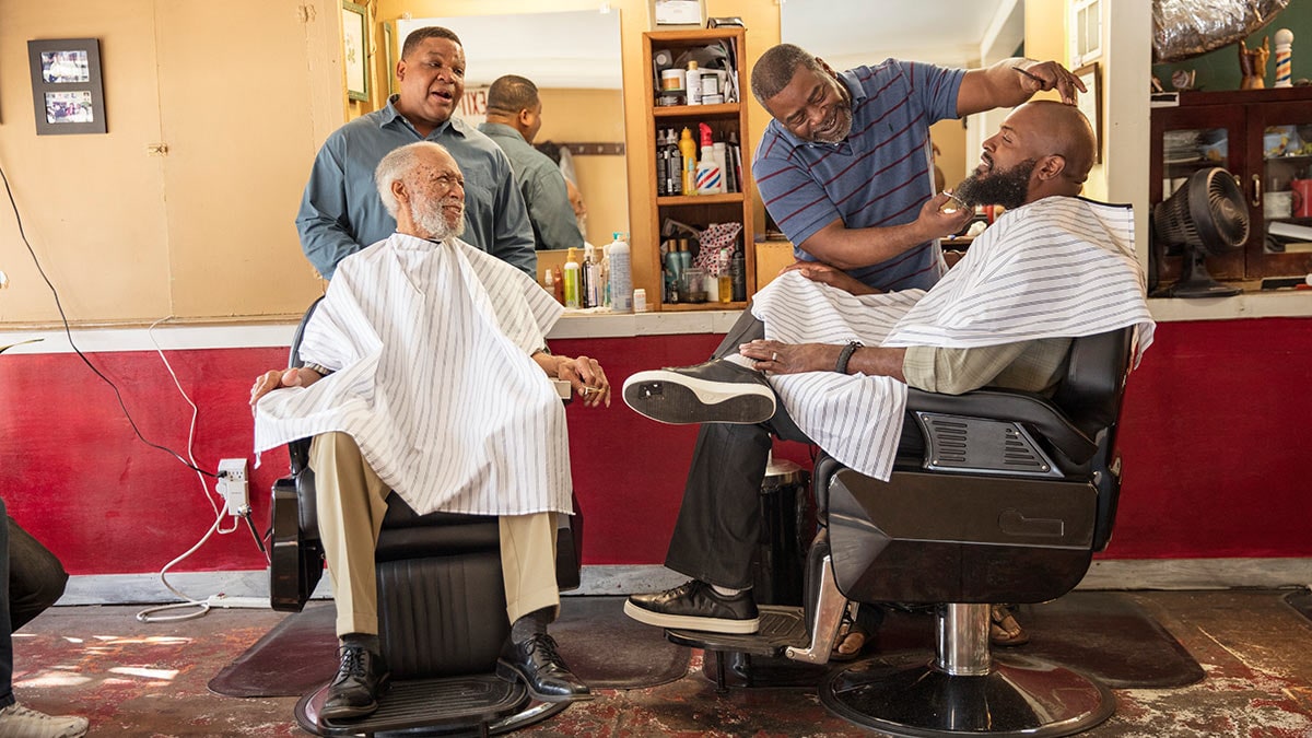 A group of African American men in a barbershop.