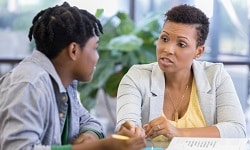 Woman counseling a teenager