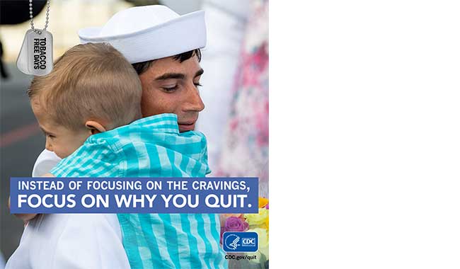 Navy service member hugging his son
