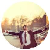 happy man in a business suit with outstretched arms