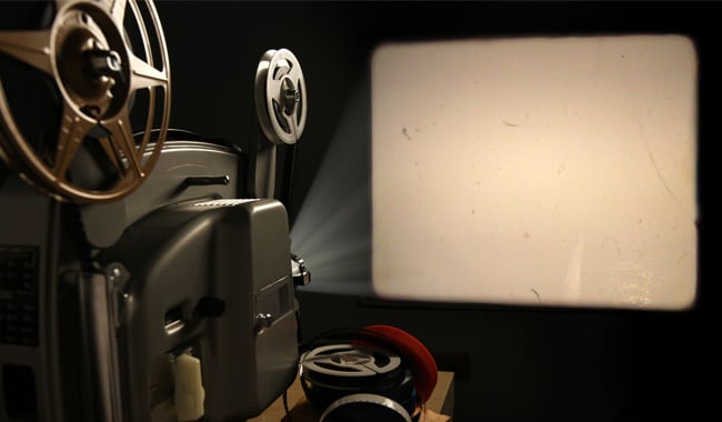 film projector projecting on a blank screen