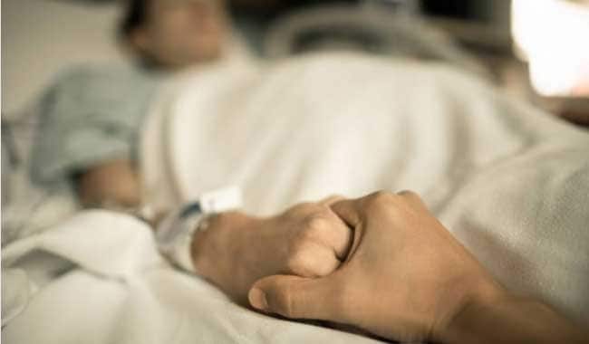 Diseases and Death - person holding hand of someone in hospital bed