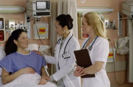doctor and nurse talking to a patient