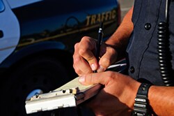 Police officer writing a traffic ticket