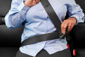 Photo of a woman buckling her seat belt