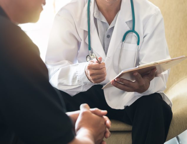Men's health exam with doctor or psychiatrist working with patient