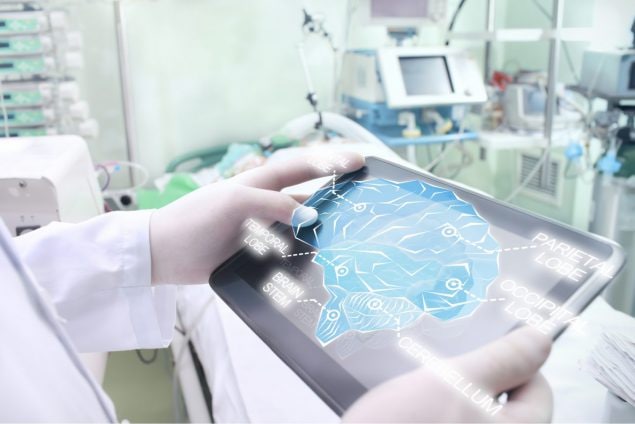 A doctor using a tablet to view a visual representation of the different parts of the human brain