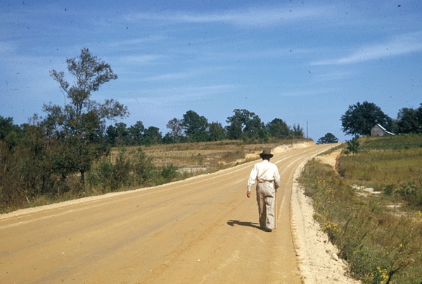 Man walking down dirt road