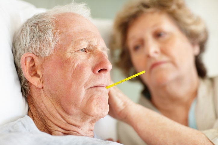 Worried senior woman comforting a sick elderly man.