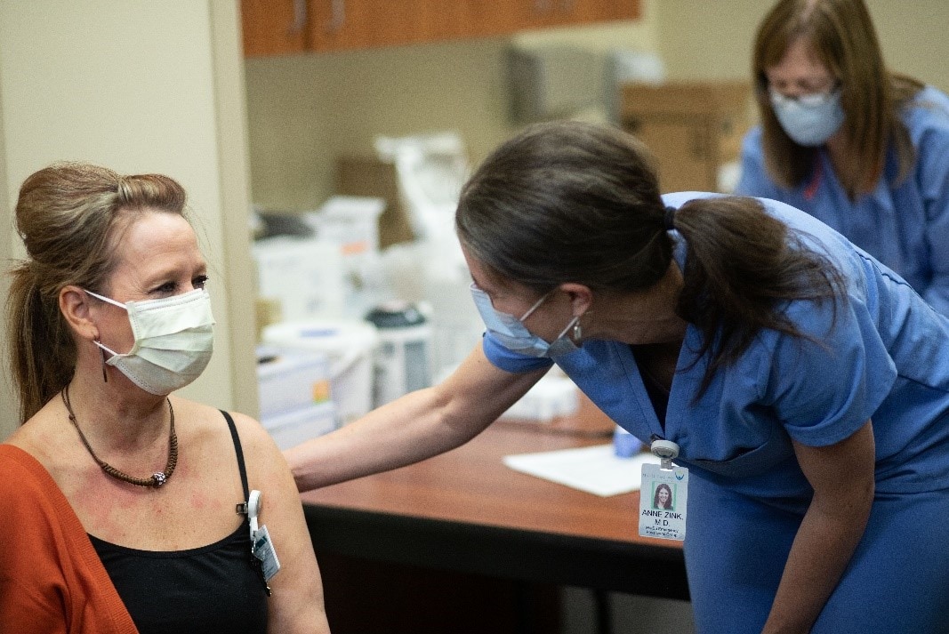 woman vaccine recipient with healthcare worker