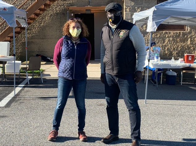 man and woman in masks at a community event